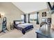 Bedroom featuring a comfortable bed, ample natural light, and a vanity area at 1099 S Walden Way # 205, Aurora, CO 80017