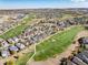 Stunning aerial view of golf course community and homes surrounded by lush green fairways at 8101 S Quatar Cir, Aurora, CO 80016