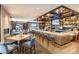 Chic bar area with stylish seating, well-stocked shelves, and warm lighting for relaxing ambiance at 8101 S Quatar Cir, Aurora, CO 80016