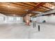 Unfinished basement with exposed wooden rafters and painted white walls at 8101 S Quatar Cir, Aurora, CO 80016