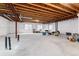 Unfinished basement with exposed wooden rafters and painted white walls at 8101 S Quatar Cir, Aurora, CO 80016