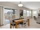 Inviting dining room with a wooden table, natural light, and a seamless transition to the outdoor deck at 8101 S Quatar Cir, Aurora, CO 80016