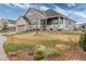 Inviting two-story home with a well-kept lawn, a brick-accented garage, and a charming covered front porch at 8101 S Quatar Cir, Aurora, CO 80016