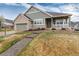 Charming two-story home with a manicured lawn and inviting front porch perfect for enjoying the outdoors at 8101 S Quatar Cir, Aurora, CO 80016