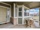 Charming front porch featuring a cozy seating area, a well-lit entrance, and inviting outdoor ambiance at 8101 S Quatar Cir, Aurora, CO 80016