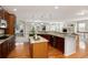 Open kitchen with wooden cabinets, granite countertops, and an island with an open floorplan at 8101 S Quatar Cir, Aurora, CO 80016