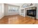 Bright living room with stone fireplace, hardwood floors, and lots of natural light at 8101 S Quatar Cir, Aurora, CO 80016