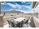 Spacious outdoor patio with a dining table and seating covered in snow at 8101 S Quatar Cir, Aurora, CO 80016