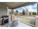 Covered porch with outdoor grill featuring views of the front yard landscape at 8101 S Quatar Cir, Aurora, CO 80016