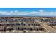 Wide aerial view of a suburban community featuring matching homes and a distant mountain range at 8501 S Rome Way, Aurora, CO 80016