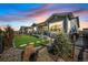 Beautiful backyard with a well manicured lawn, stone landscaping and trees at 8501 S Rome Way, Aurora, CO 80016