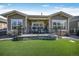 Backyard featuring a patio, faux grass, and stylish outdoor furniture at 8501 S Rome Way, Aurora, CO 80016