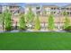 Enjoy outdoor living on artificial turf bordered by a fence and professional landscaping for low maintenance at 8501 S Rome Way, Aurora, CO 80016