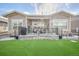 Enjoy outdoor living with this home's artificial turf, covered patio, and professionally designed landscaping at 8501 S Rome Way, Aurora, CO 80016