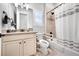 Accessible bathroom features updated fixtures, safety bars and shower curtain at 8501 S Rome Way, Aurora, CO 80016