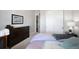 Comfortable bedroom featuring neutral tones, carpet flooring and closet with sliding doors at 8501 S Rome Way, Aurora, CO 80016
