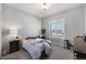 Bright bedroom featuring neutral tones, carpet flooring and a large window at 8501 S Rome Way, Aurora, CO 80016
