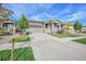 Inviting home featuring a well-manicured lawn, mature trees, and a large driveway at 8501 S Rome Way, Aurora, CO 80016