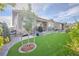 A beautiful home showcasing artificial turf, a cozy covered patio, and stone accents for added curb appeal at 8501 S Rome Way, Aurora, CO 80016
