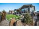 This home features artificial turf, professionally designed landscaping, stone accents, and a charming covered patio at 8501 S Rome Way, Aurora, CO 80016