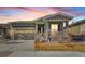 Charming single-Gathering home featuring stone accents, a covered porch, and a well-maintained front yard at 8501 S Rome Way, Aurora, CO 80016