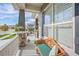 Cozy front porch featuring a bench seat, columns, and a hanging basket at 8501 S Rome Way, Aurora, CO 80016