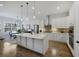 Open concept kitchen with center island, white cabinets, stainless steel appliances, and adjacent dining area at 8501 S Rome Way, Aurora, CO 80016