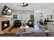 Cozy living room with a fireplace, comfortable seating, and an open layout at 8501 S Rome Way, Aurora, CO 80016