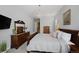 Spacious bedroom featuring a queen bed, dresser, and serene decor with a decorative chandelier above at 8501 S Rome Way, Aurora, CO 80016