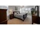 Bright main bedroom with a plush queen bed, a decorative chandelier, and elegant furnishings at 8501 S Rome Way, Aurora, CO 80016