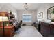 Home office with wood furniture, carpet flooring and a large window at 8501 S Rome Way, Aurora, CO 80016