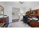 Home office featuring wood furniture, carpet flooring, and an open doorway at 8501 S Rome Way, Aurora, CO 80016