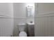 Cozy bathroom featuring a toilet, sink with cabinet, and a vanity mirror with a light at 5810 S Greenwood St, Littleton, CO 80120
