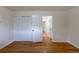 Bedroom featuring hardwood floors, two windows and a closet with sliding doors at 5810 S Greenwood St, Littleton, CO 80120