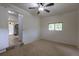 Bedroom featuring carpet, a window for natural light, and access to the kitchen at 5810 S Greenwood St, Littleton, CO 80120