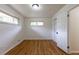 Light-filled bedroom featuring hardwood floors and two bright windows at 5810 S Greenwood St, Littleton, CO 80120