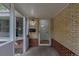 Charming covered entryway with brick walls, a glass door, and traditional fixtures enhancing curb appeal at 5810 S Greenwood St, Littleton, CO 80120