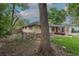 A tan brick home is surrounded by mature trees and features a brick and gravel path, a small fence, and a large tree at 5810 S Greenwood St, Littleton, CO 80120
