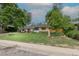 Charming single-story home featuring a well-maintained lawn, mature trees, and brick exterior elements at 5810 S Greenwood St, Littleton, CO 80120