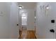 Hallway with hardwood floors, leading to the bathroom and other rooms in the home at 5810 S Greenwood St, Littleton, CO 80120