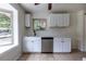 Bright kitchen features tile floors, white cabinets, stainless steel appliances, and a window above the sink at 5810 S Greenwood St, Littleton, CO 80120