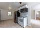 Bright kitchen features tile floors, white appliances, and a view into the dining room and backyard at 5810 S Greenwood St, Littleton, CO 80120