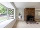 Bright living room features large windows, a brick fireplace, and open access to other living spaces at 5810 S Greenwood St, Littleton, CO 80120