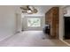 Spacious living room features carpet, a brick fireplace, and a bay window overlooking the front yard at 5810 S Greenwood St, Littleton, CO 80120