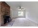 Spacious living room features a brick fireplace, plush carpet, and a modern ceiling fan at 5810 S Greenwood St, Littleton, CO 80120