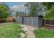 Outdoor shed offering practical storage, set in a yard with shade trees at 5810 S Greenwood St, Littleton, CO 80120