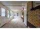 Sunroom featuring exposed brick, multiple windows offering natural light, and neutral carpet at 5810 S Greenwood St, Littleton, CO 80120