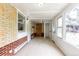 Sunroom featuring exposed brick walls, multiple windows, and access to a closet at 5810 S Greenwood St, Littleton, CO 80120