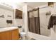 This bathroom features a single sink vanity, framed mirror and built in shelving in the shower and above the toilet at 1030 E 78Th Pl, Denver, CO 80229
