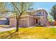 Inviting two-story home featuring a well-maintained lawn, dual garages, and charming curb appeal on a sunny day at 1030 E 78Th Pl, Denver, CO 80229